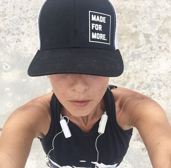 A female runner wearing a hat that says "Made for More" (Run Like A Mother: A Beginner's Guide to Running Kristen Llorca Contributor Miami Mom Collective)