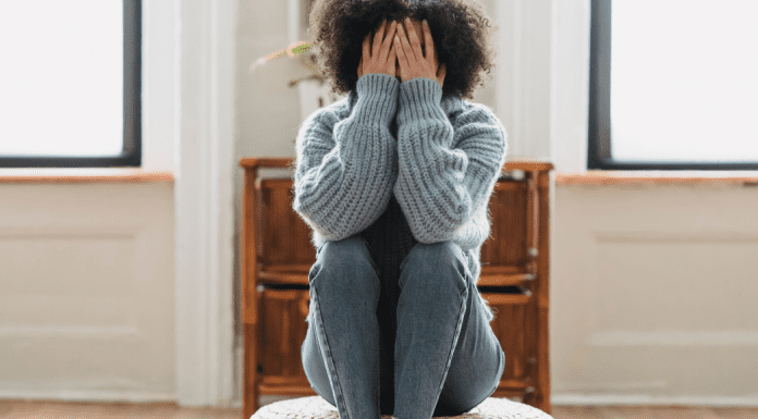 Speak Up: You Matter, Your Opinions Matter Image: A woman sitting down with her head in her hands (Speak Up: You Matter, Your Opinions Matter Rachelle Haime Contributor Miami Mom Collective)