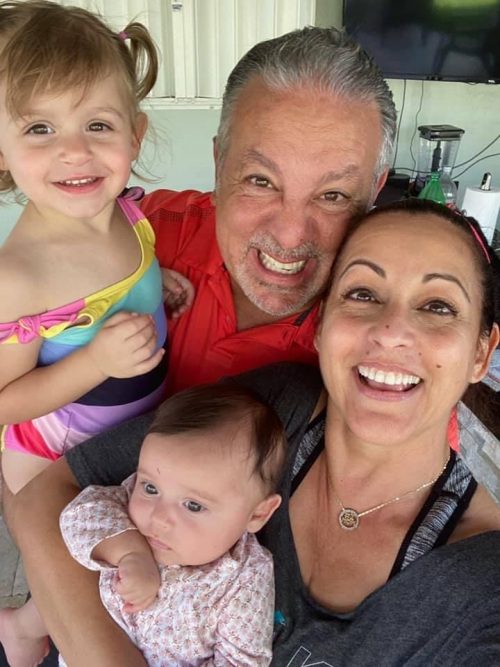 Alina with her husband and grandchildren (Wisdom and Reflections on Motherhood by 3 Generations of Miami Moms Alisa Britton Contributor Miami Mom Collective)