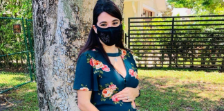 An expectant mom with her MIA Mom face mask (Booster Shots, Breakthrough Cases & the Latest on COVID Vaccine Safety Lynda Lantz Contributor Miami Mom Collective)