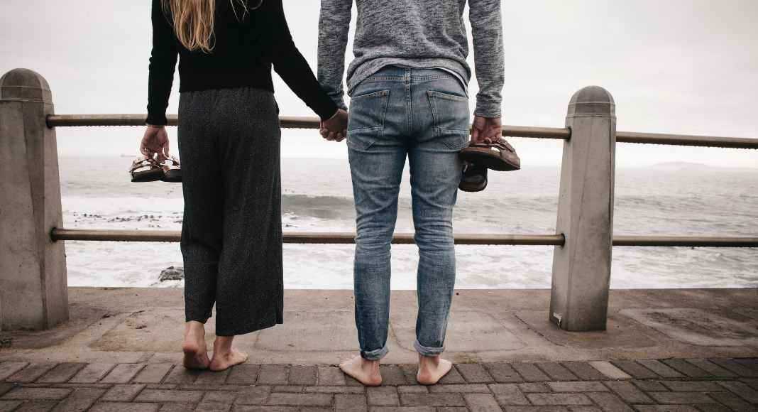 Image: A couple standing side by side on a pier (The Long Wait to Become a Mom Kristin Parke Contributor Miami Mom Collective)