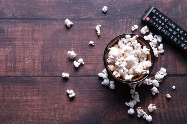 A bowl of popcorn and a remote control (Fighting Summer Boredom Lorena Lougedo Contributor Miami Mom Collective)