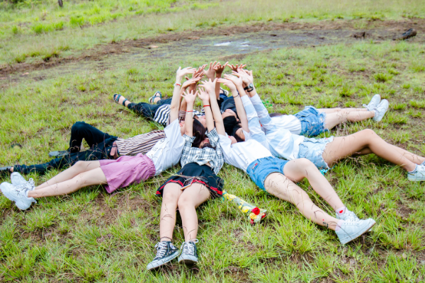 A group of people lying out in the grass (Fighting Summer Boredom Lorena Lougedo Contributor Miami Mom Collective)