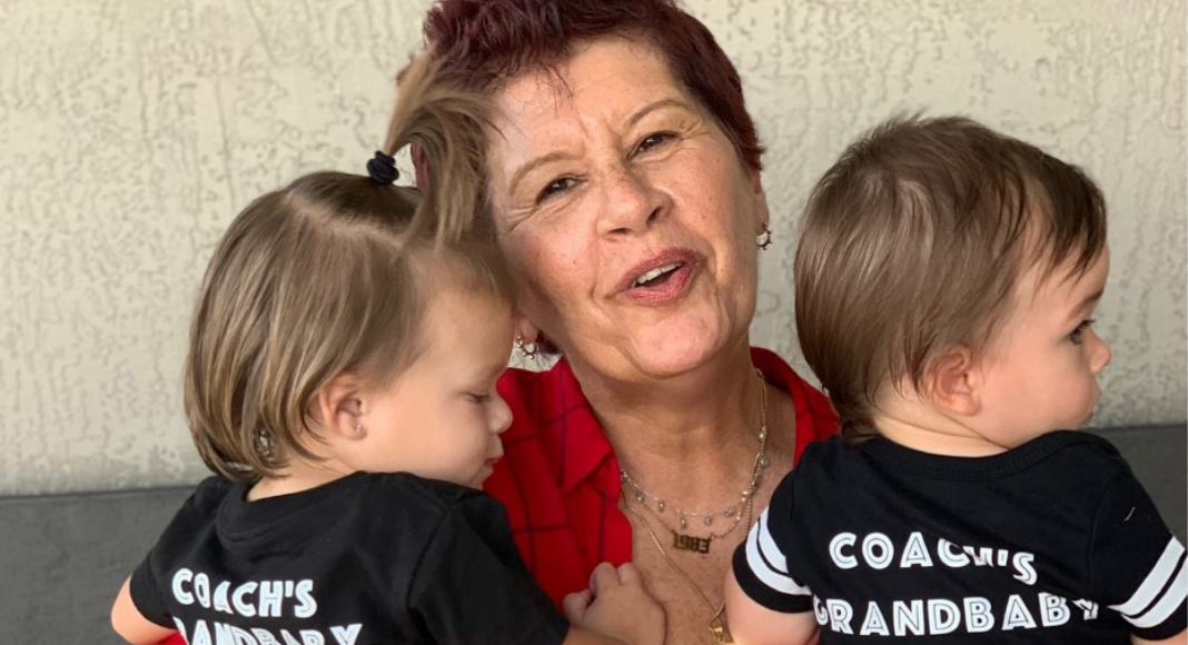 Image: Holly holding 2 of her grandchildren (I've Graduated to Grand! The Perks of Adding Grand to the Title of Mom Holly Farver Contributor Miami Mom Collective)