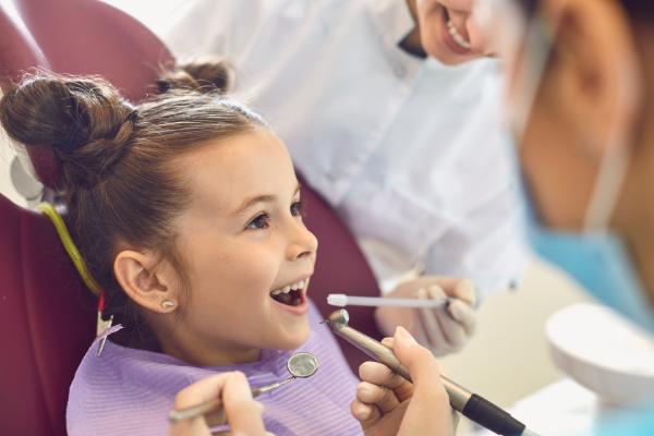 A little girl at the dentist (Toothbrushing Power Struggles: 3 Tips & Tricks | Dr. Bob Pediatric Dentist Lynda Lantz Contributor Miami Mom Collective)