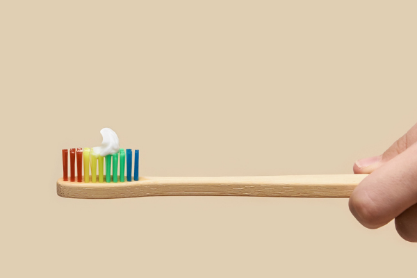 A colorful toothbrush with a pea-sized amount of tooth paste (Toothbrushing Power Struggles: 3 Tips & Tricks | Dr. Bob Pediatric Dentist Lynda Lantz Contributor Miami Mom Collective)