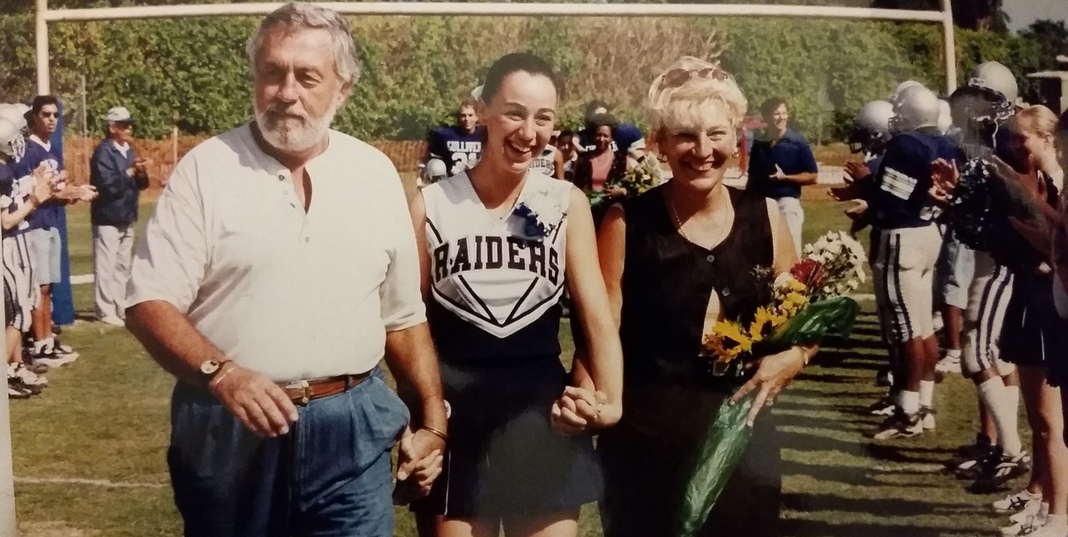 Sandra with her parents at a high school football game (Love Where You Live: Why I Love Living In Pinecrest Sandra Jacquemin Contributor Miami Mom Collective)