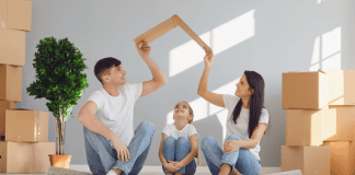 Moving with Children: 4 Helpful Tips Image: A father and mother sitting on the floor with their daughter, surrounded by moving boxes (Moving with Children: 4 Helpful Tips Jessica Socarras Contributor Miami Mom Collective)