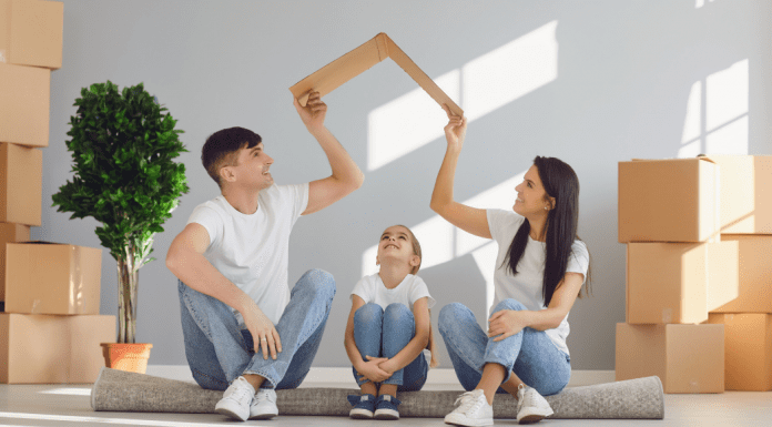 Moving with Children: 4 Helpful Tips Image: A father and mother sitting on the floor with their daughter, surrounded by moving boxes (Moving with Children: 4 Helpful Tips Jessica Socarras Contributor Miami Mom Collective)