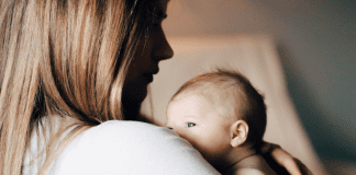 A mom holding her newborn (Choosing Joy and Enjoying the Chaos Kristin Parke Contributor Miami Mom Collective)