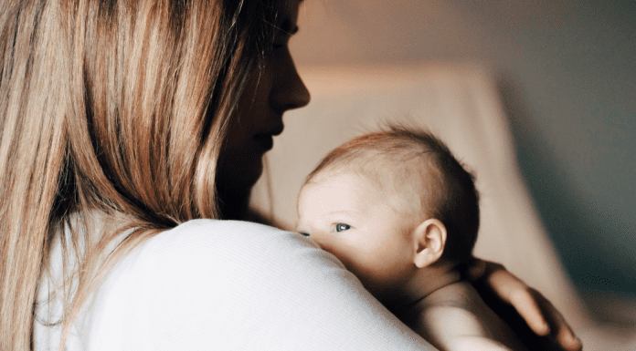 Choosing Joy and Enjoying the Chaos A mom holding her newborn (Choosing Joy and Enjoying the Chaos Kristin Parke Contributor Miami Mom Collective)