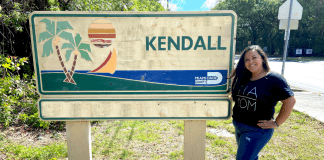 Love Where You Live: Why I Love Kendall Krystal posing by a Kendall sign (Love Where You Live: Why I Love Kendall Krystal Giraldo Contributor Miami Mom Collective)
