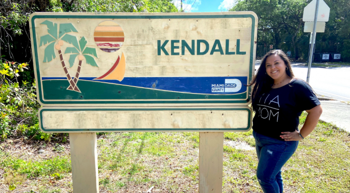 Krystal posing by a Kendall sign (Love Where You Live: Why I Love Kendall Krystal Giraldo Contributor Miami Mom Collective)