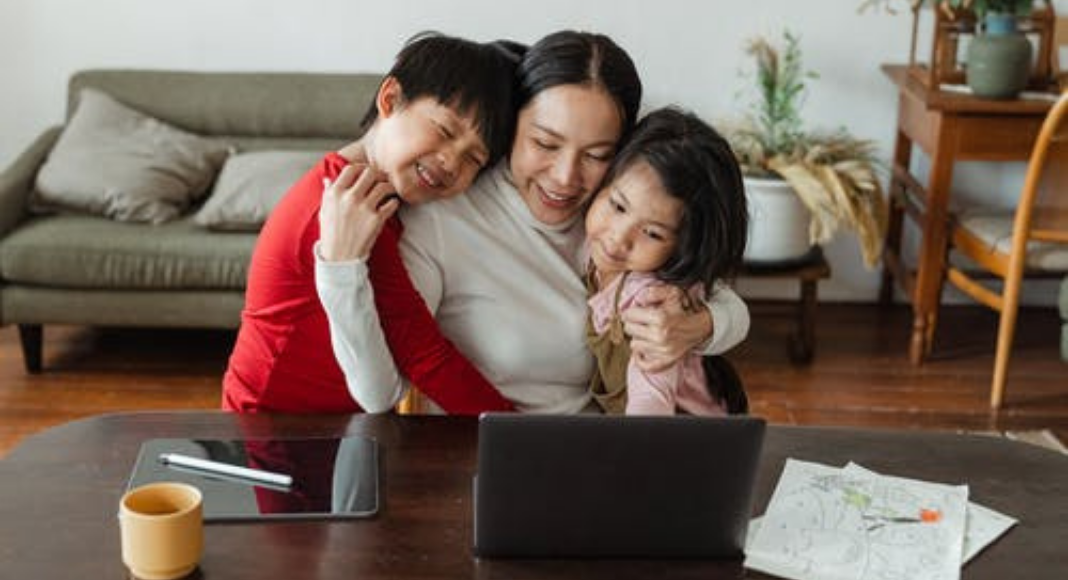 Image: A mom hugging her son and daughter (Living During a Pandemic: Am I a Better Mom as a Result? Holly Farver Contributor Miami Mom Collective)