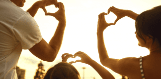 A family making hearts with their hands (Love Where You Live: Why I Love Living in Hialeah Lorena Lougedo Contributor Miami Mom Collective)