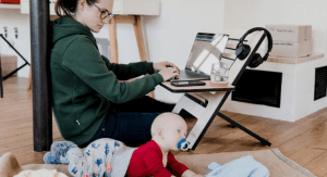 A mom working from home while watching her baby (Daycare & Preschool During the Ongoing Pandemic Bella Behar Contributor Miami Mom Collective)