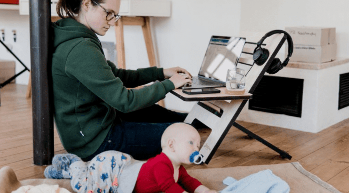 A mom working from home while watching her baby (Daycare & Preschool During the Ongoing Pandemic Bella Behar Contributor Miami Mom Collective)
