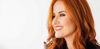 Dacia putting on some bright red lipstick (Momma Self-Care: People Love You the Way You Love Yourself Dacia Wiegandt Contributor Miami Mom Collective)