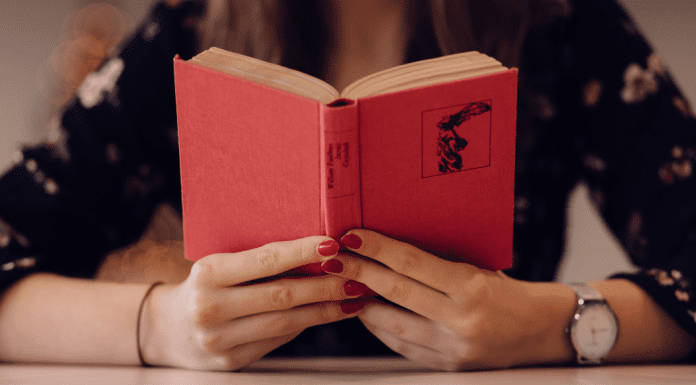 A woman holding an open book (Let's Celebrate: National Reading Across America Day Lorena Lougedo Contributor Miami Mom Collective)