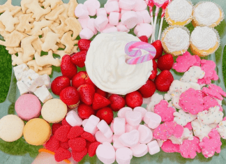 Valentine’s Day: Fun, Family-Friendly Ideas A Valentine's Day themed snack try with animal crackers, marshmallows, macarons, strawberries, and cupcakes