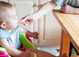 I’m a Dietitian, and I Hated Feeding My Baby Solid Food (At First) | Part 3 An older sibling feeds a toddler a cracker