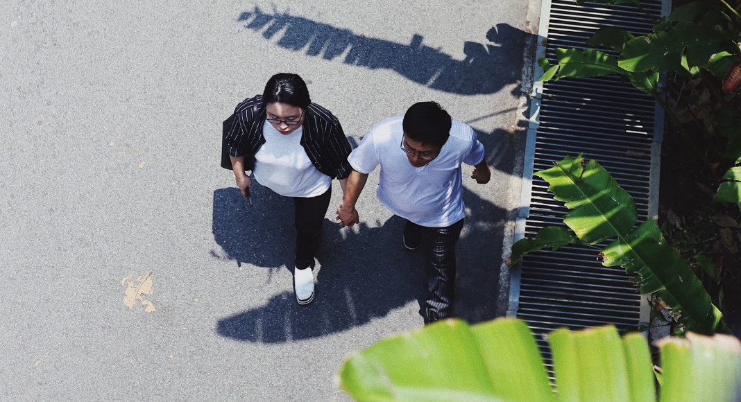 A couple holding hands and going for a walk (Creative Date Night Ideas on a Budget Becky Gonzalez Contributor Miami Mom Collective)