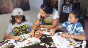 Illiett working on vision boards with her kids