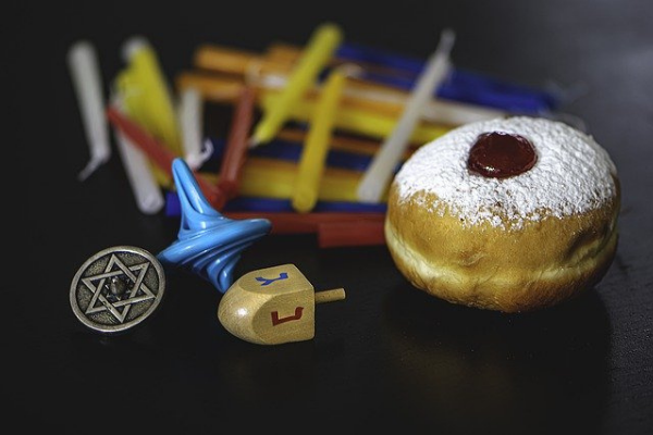 Image: Hanukkah candles, gelt, dreidels, and sufganiyot