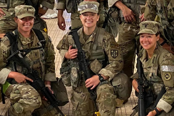 Image: 3 female soldiers in combat fatigues