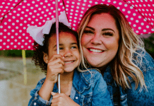 National Adoption Month: Adopting Children From Foster Care Image: A mother and daughter share smiles and an umbrella
