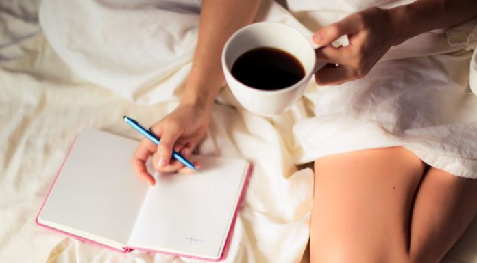 30-Day Gratitude Challenge (With Printable!) Image: A woman writing in a gratitude journal with a cup of coffee