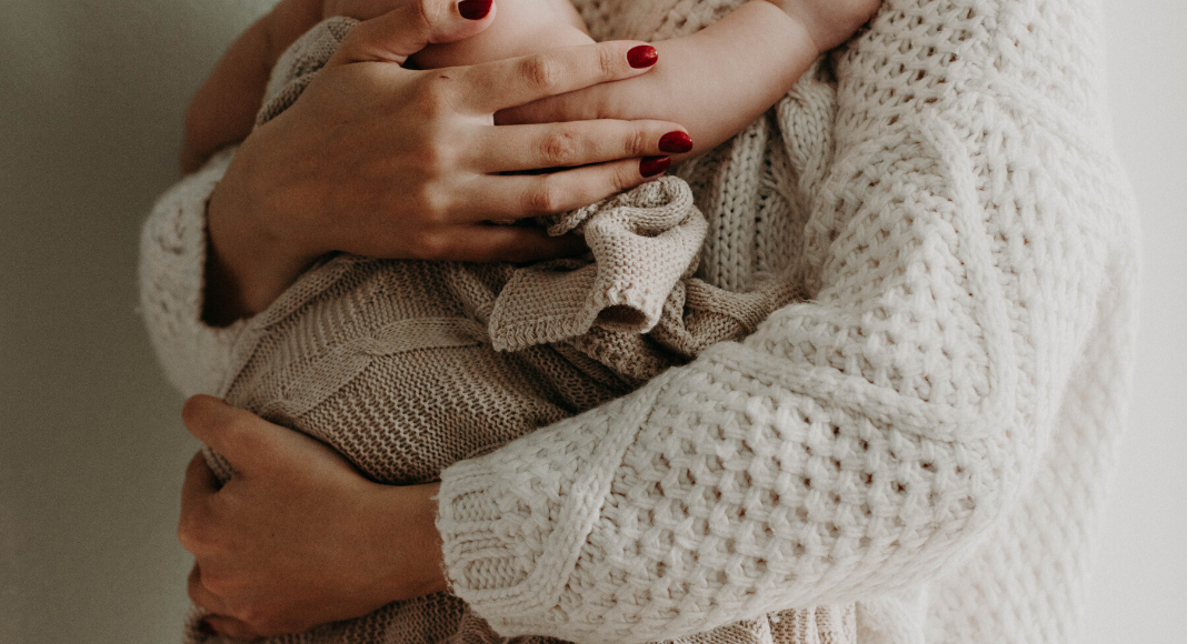 Great Habits To Form When Handling Your Baby A mother holding her baby in her arms (Great Habits To Form When Handling Your Baby Andrea Wood Contributor Miami Mom Collective)