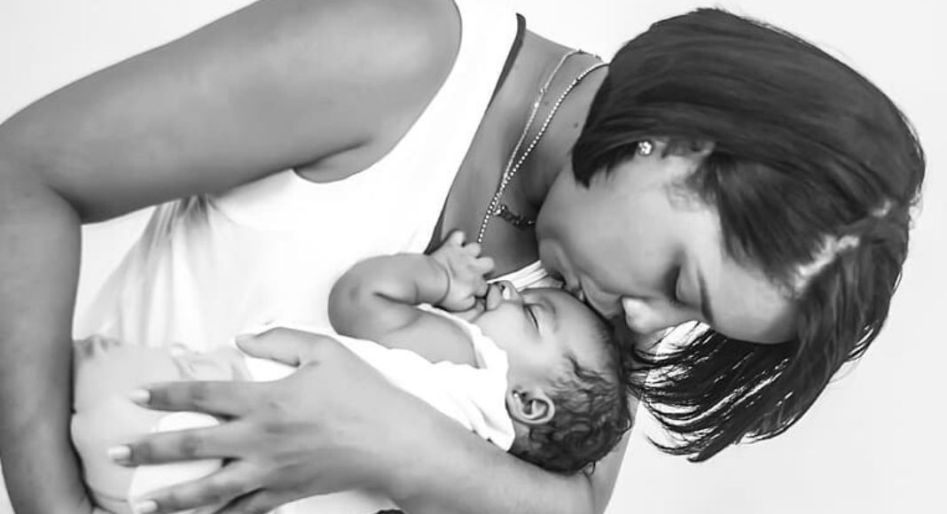 When You Least Expect to Celebrate: 3 Tips for Black Moms Image: A mother holds and kisses her sleeping infant