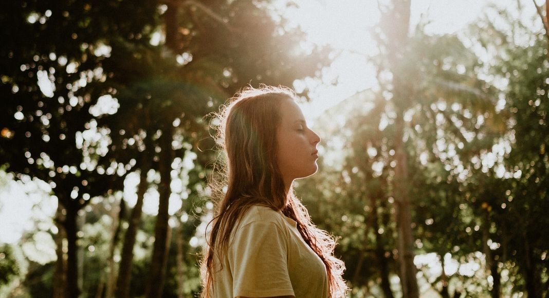 Mental Health and Wellness | MOM STRONG Image: A woman walking in the woods