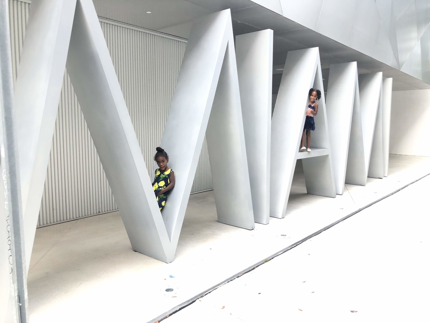 girls sitting on miami sign 3 Things We Did in Miami While Practicing Social Distancing Janeris Marte Contributor Miami Moms Blog