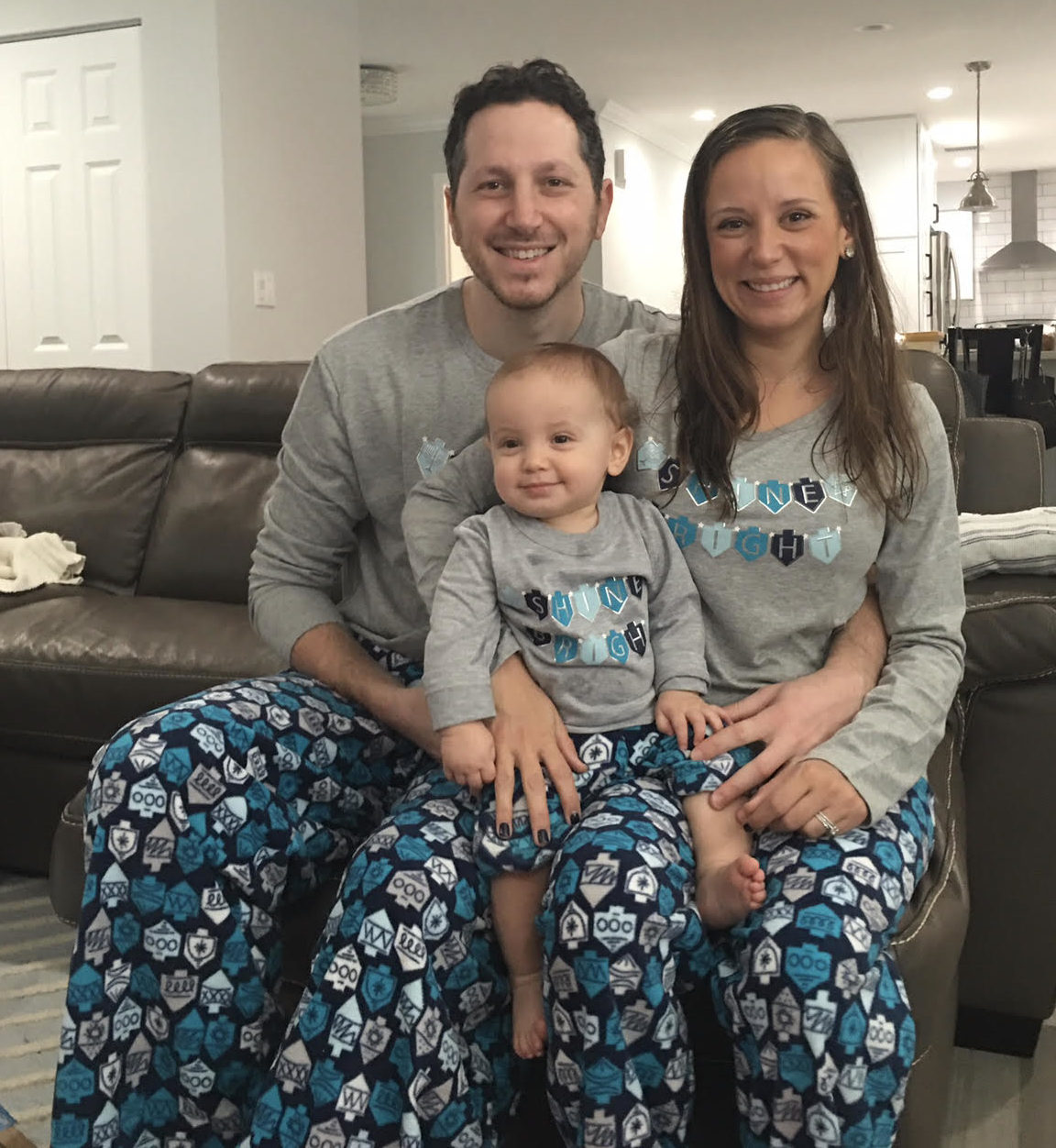 Image: A family poses for a photo with matching Hanukkah PJs