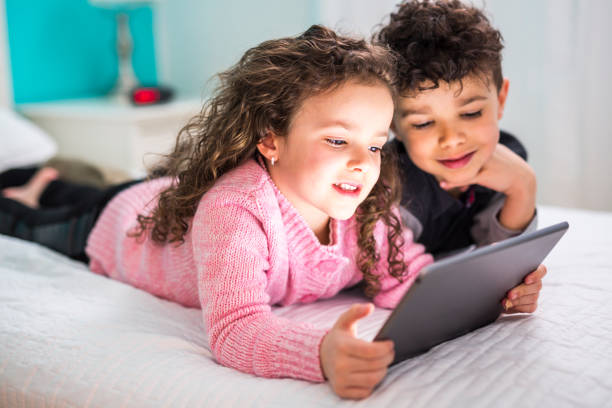 Two Cute brother and sister enjoying tablet at home Comcast Xfinity: Helping Families Safely Enjoy the Internet Valerie Barbosa Contributor Miami Moms Blog