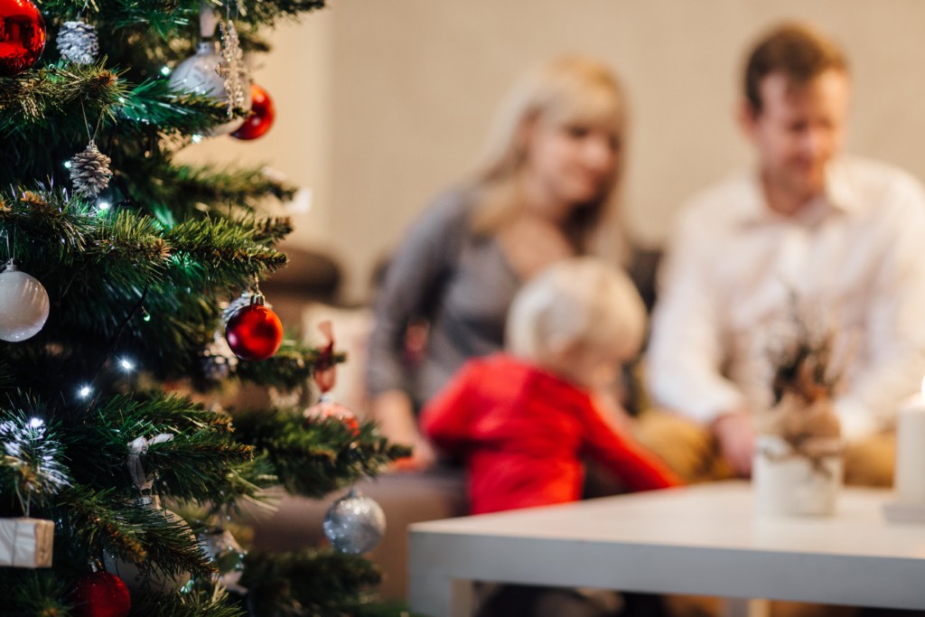 Accepting the Invitation to Play with our Kids this Holiday Season playing by christmas tree Accepting the Invitation to Play with our Kids this Holiday Season Bethany Pappas Contributor Miami Moms Blog