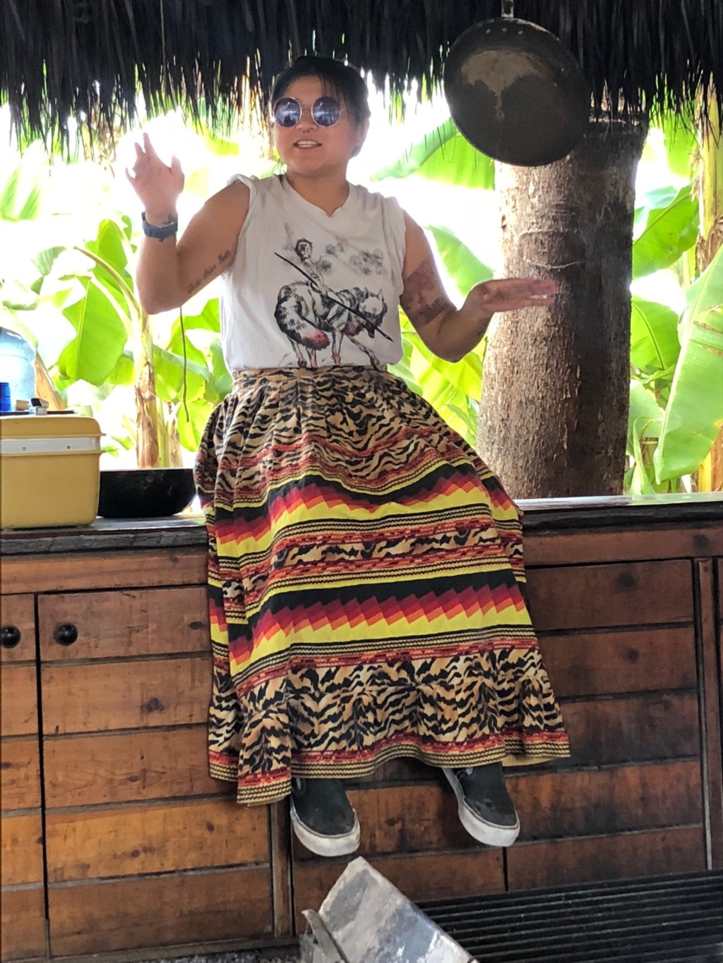 Image: A woman wears a cooking chickee fire skirt