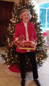 Image: Betty, standing in front of a Christmas tree