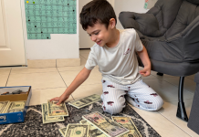Image: A child engaging in a money-themed home learning activity