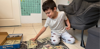 Homeschooling My Neurodivergent Child: What’s Working For Us Image: A child engaging in a money-themed home learning activity