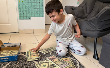 Image: A child engaging in a money-themed home learning activity