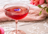 pink brunch cocktail with flowers in background
