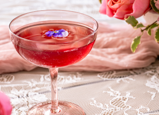 pink brunch cocktail with flowers in background