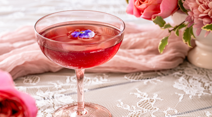 pink brunch cocktail with flowers in background