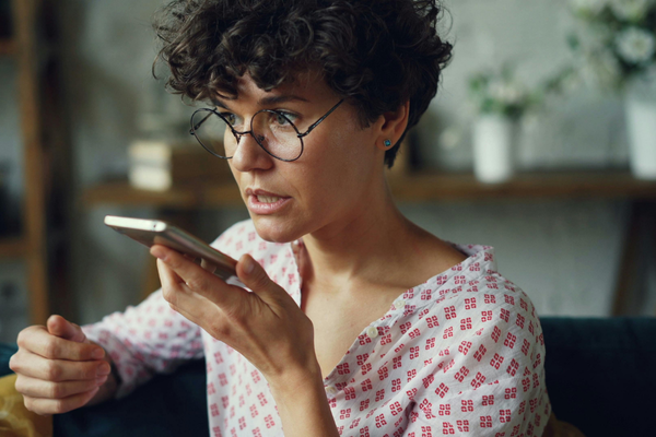 Woman doing a voice note on her phone 