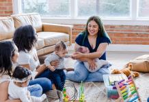 The Group Chat Isn’t Just Small Talk, It’s Survival Group of women with babies playing on the floor
