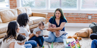 The Group Chat Isn’t Just Small Talk, It’s Survival Group of women with babies playing on the floor