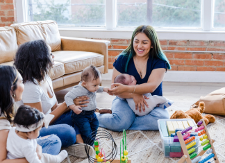 Group of women with babies playing on the floor